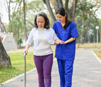 caregiver assists an elderly woman