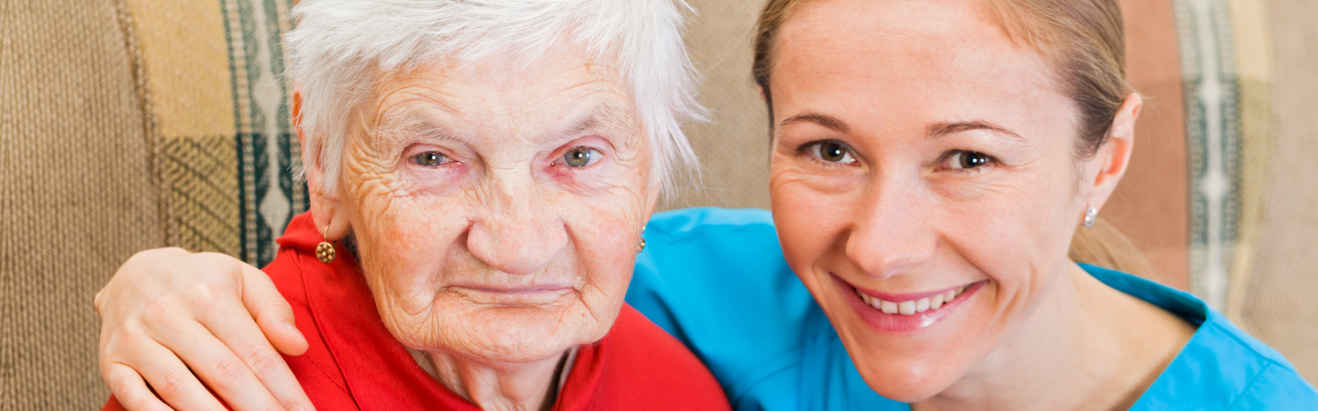caregiver and a senior woman smiling